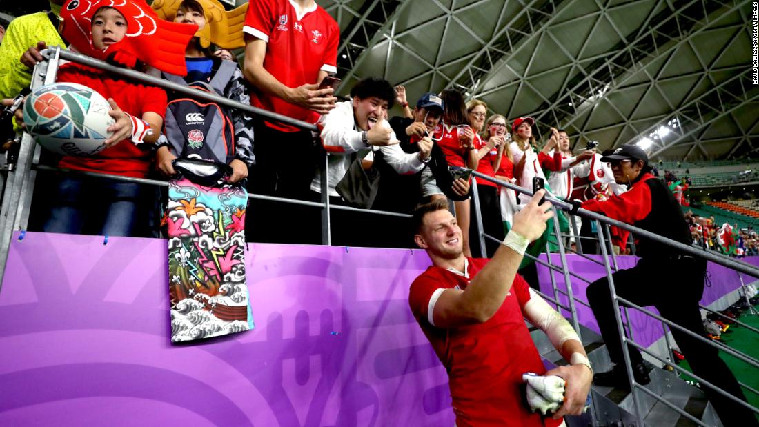 Wales&#39; Dan Biggar takes selfies with fans at the end quarterfinal.