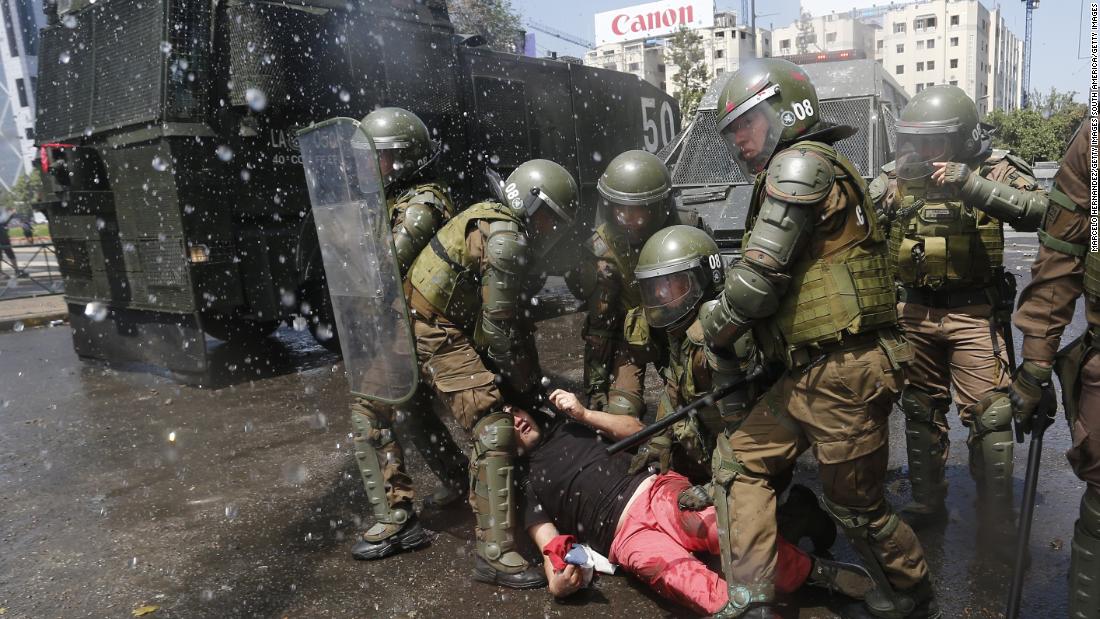 Anti-government demonstrators clash with police as they protest against cost of living increases on October 20 in Santiago, Chile.