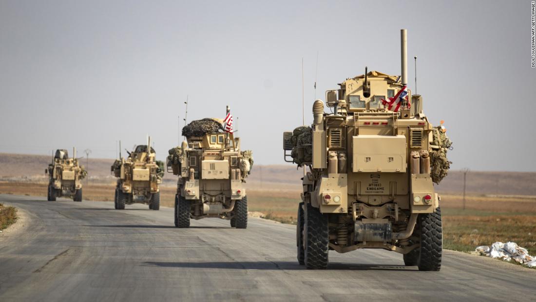 US military vehicles drive after pulling out of their base in the northern Syrian town of Tal Tamr on Sunday, October 20.