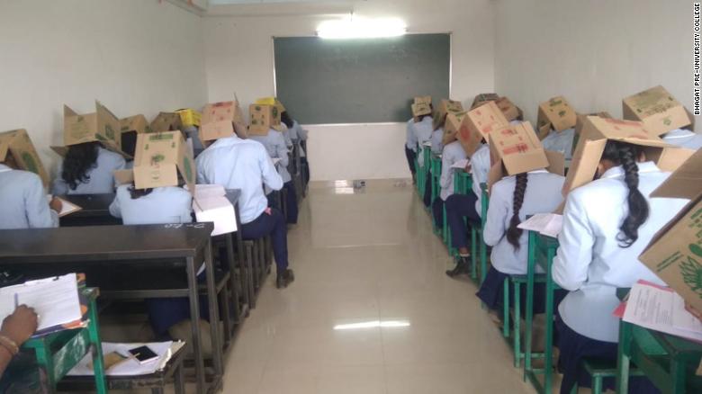 Students at an Indian school wore cardboard boxes on their heads as an anti-cheating measure on October 16, 2019.