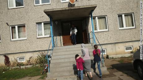 A Chechen family seeking asylum in Germany walk into their temporary home in Letschin. 