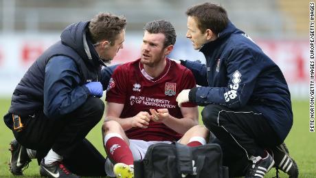 NORTHAMPTON, ENGLAND - FEBRUARY 06:  Zander Diamond of Northampton Town recieves treatment from physio Anders Braastad and Dr Andrew Odwell after a clash of heads which left him concussed during the Sky Bet League Two match between Northampton Town and York City at Sixfields Stadium on February 6, 2016 in Northampton, England.  (Photo by Pete Norton/Getty Images)