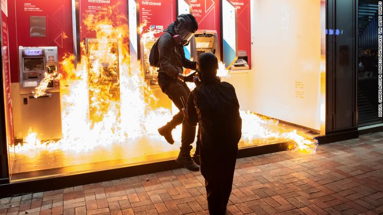 Protesters set a Bank of China branch on fire in Hong Kong on October 13, 2019.