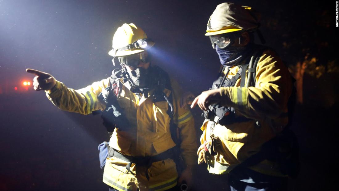 Two firefighters discuss a plan while battling the wildfire in Geyserville.