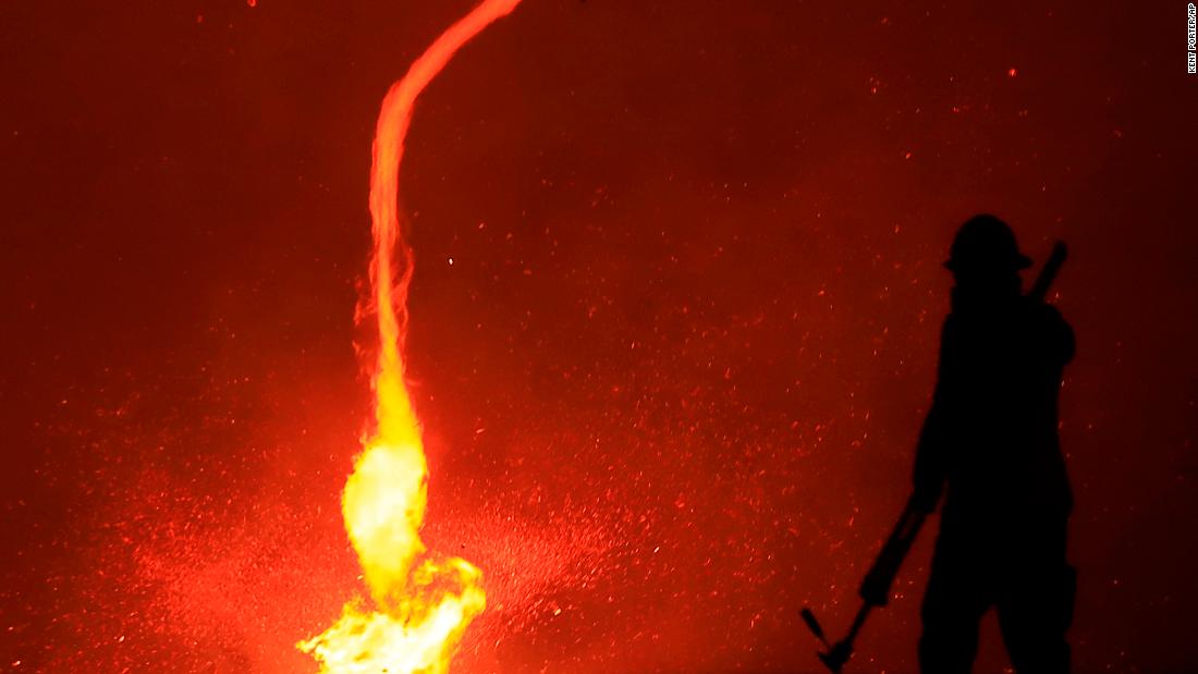 A fire whirl whips across dry brush as the Kincade Fire spreads through Sonoma County on October 24.