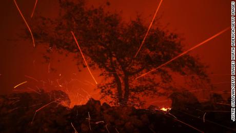 Embers blow in the wind as the Kincaide Fire burns in Geyserville, California. 