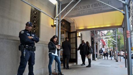 NYPD counterterrorism officer, far left, takes up station at Temple Emanu-El in October 2018, as religious institutions boost security in the aftermath of Pittsburgh&#39;s Synagogue shooting.