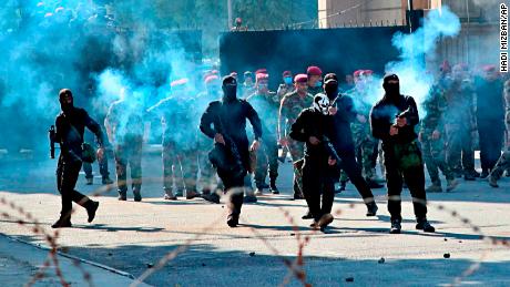 Security forces fire tear gas to disperse anti-government protesters in Baghdad.