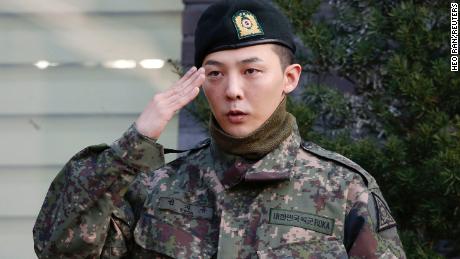 G-Dragon poses for photographs after being discharged from the army in Yongin, South Korea, on October 26, 2019. 