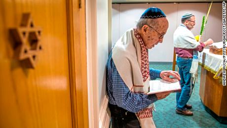 Joe Charny reads during a morning minyan prayer service at Congregation Beth Shalom.