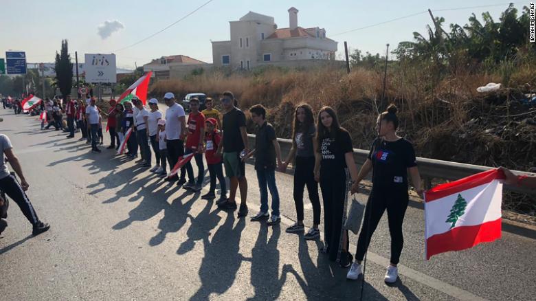 Lebanese men, women and children link arms to form a 105-mile human chain.