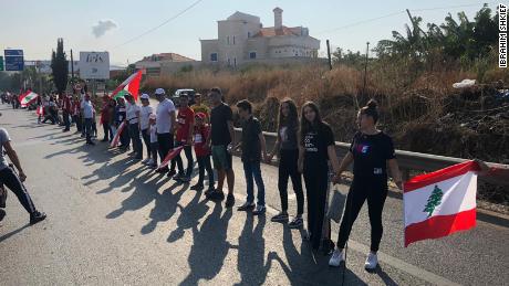 Lebanese men, women and children link arms to form a 105-mile human chain.