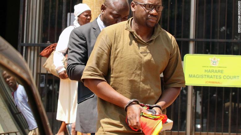 Zimbabwean pastor and activist Evan Mawarire clutches his Bible after being arrested and sent to Harare&#39;s Magistrates Court.