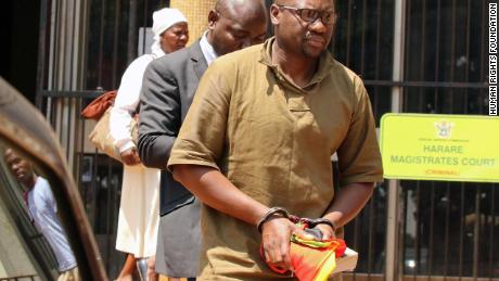 Zimbabwean pastor and activist Evan Mawarire clutches his Bible after being arrested and sent to Harare&#39;s Magistrates Court.