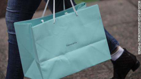 A shopper carrying a Tiffany retail bag on Fifth Avenue in New York.