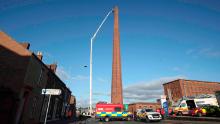 Chimney rescue. A hydraulic platform is raised at Dixon&#39;s Chimney in Carlisle, Cumbria, where a man, whose condition is currently unknown, continues to hang upside down from the top of the chimney 270ft up. Picture date: Monday October 28, 2019. Local reports said shouts and wailing could be heard coming from the chimney in the early hours of this morning before police arrived on the scene. See PA story POLICE Chimney. Photo credit should read: Danny Lawson/PA Wire URN:47938205 (Press Association via AP Images)