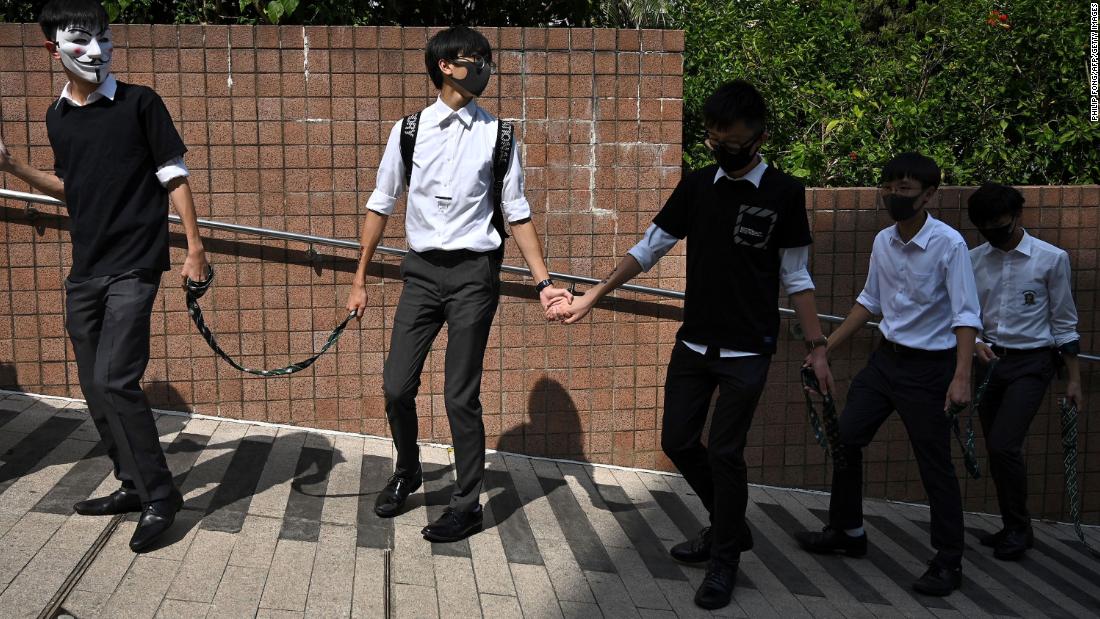 High school students take part in a human chain rally outside Kowloon park in Hong Kong on October 25.