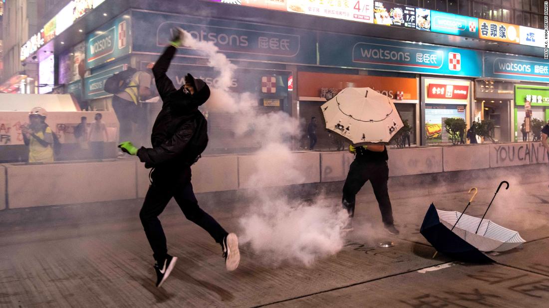 A protester throws a tear gas canister on October 27 in Hong Kong. 