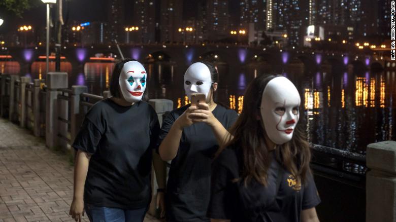 Hong Kong protesters wear a mask on October 18, 2019, in defiance of a government ban on face masks in public assemblies.