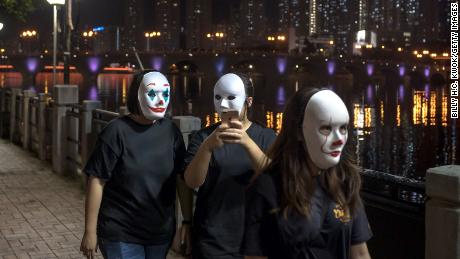 Hong Kong protesters wear a mask on October 18, 2019, in defiance of a government ban on face masks in public assemblies.