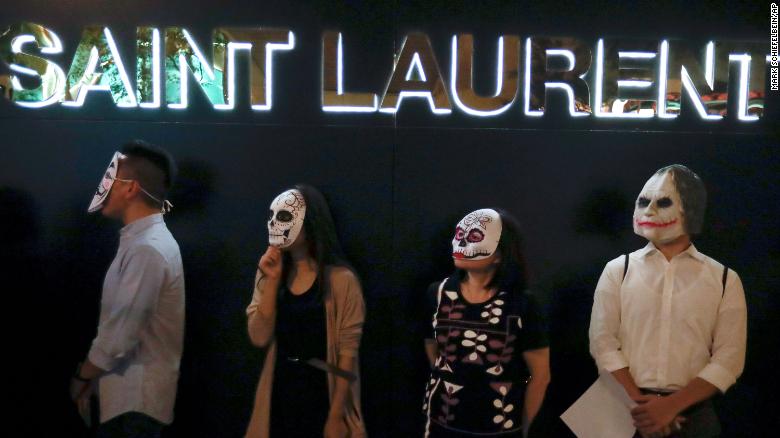 Hong Kong protesters wear masks, including one of the Joker, on October 18, 2019.