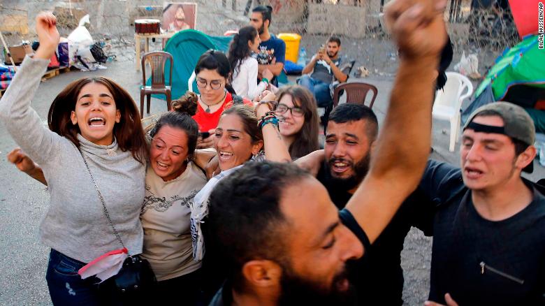 Anti-government protesters in Lebanon celebrate after Saad Hariri announced his resignation.