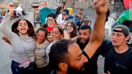 Anti-government protesters in Lebanon celebrate after Saad Hariri announced his resignation.