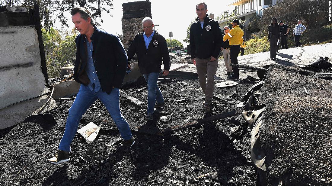 From left, California Gov. Gavin Newsom, Los Angeles City Councilman Mike Bonin and Los Angeles Mayor Eric Garcetti tour a burned home in Brentwood, California, on October 29. 