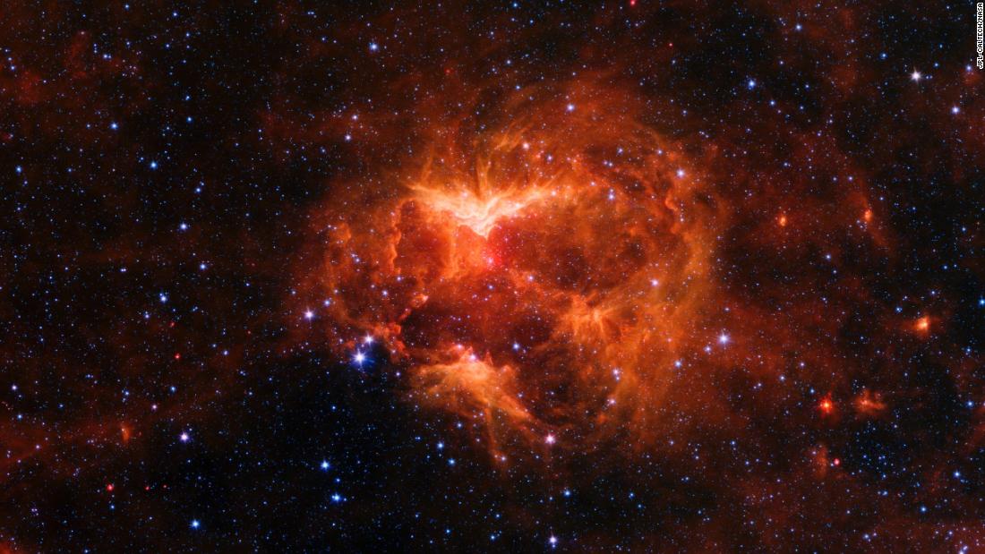 The Jack-o&#39;-lantern Nebula is on the edge of the Milky Way. Radiation from the massive star at its center created spooky-looking gaps in the nebula that make it look like a carved pumpkin.