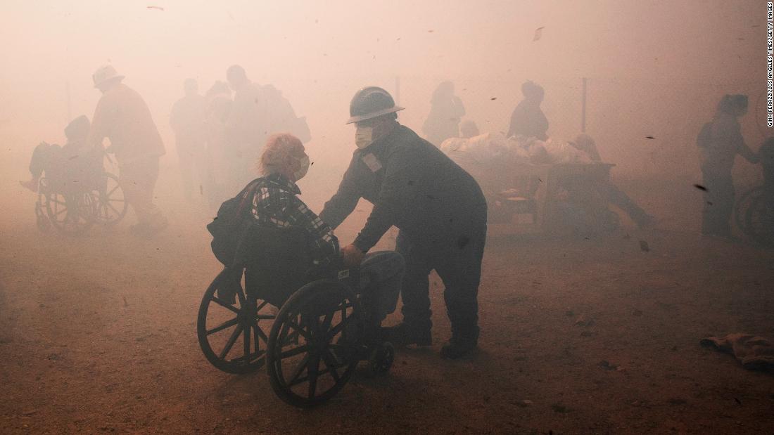 Health care workers evacuate the Riverside Heights Healthcare Center on October 30.