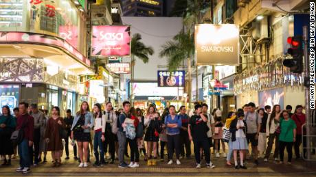 Pedestrians prepare to cross a road in the popular shopping district of Causeway Bay in Hong Kong on October 30, 2019, a day before the citys third-quarter gross domestic product (GDP) figures are released. (Photo by Anthony WALLACE / AFP) (Photo by ANTHONY WALLACE/AFP via Getty Images)