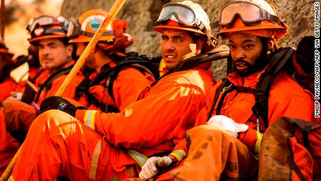 A crew of inmate firefighters takes a break from battling the Kincade Fire in Healdsburg, California.