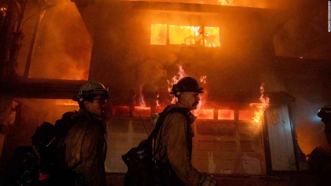 Firefighters work to prevent a blaze from spreading to other homes in San Bernardino.