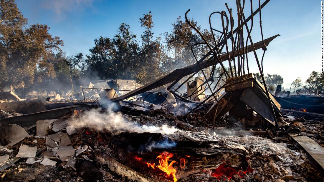 The remains of the Louis Robidoux Nature Center keep smoldering after the structure was destroyed by a wildfire in Riverside, California.