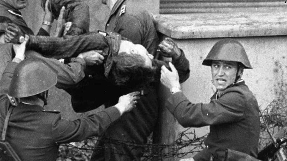 East German bricklayer Peter Fechter, 18, is carried away by border guards after being shot and fatally wounded while attempting to flee to the West in August, 1962. &lt;a href=&quot;https://www.britannica.com/topic/Berlin-Wall&quot; target=&quot;_blank&quot;&gt;Almost 200 &lt;/a&gt;people were killed attempting to cross the Wall between 1961 and 1989.