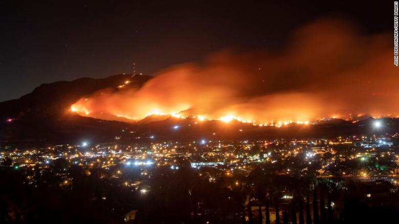 A long-exposure photo shows the Maria Fire as it races across a hillside in Santa Paula, California, on Friday, November 1.