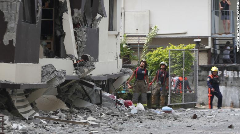 Rescuers look at the damaged condominium building after a 6.5-magnitude earthquake hit Davao City in the southern island of Mindanao on October 31, 2019.