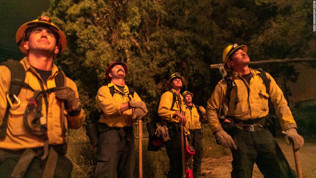 Firefighters watch the progress of a backfire near Somis.