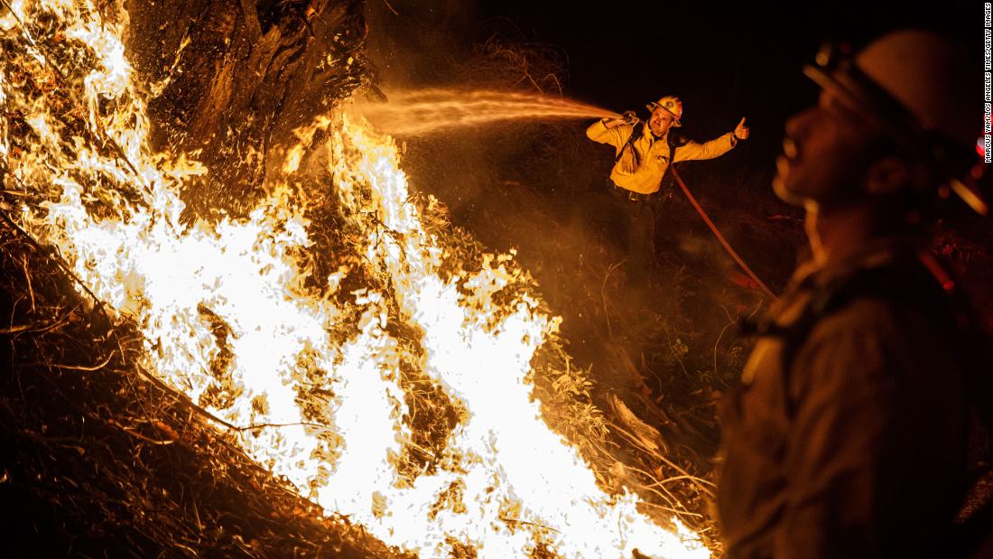 Firefighters spray water on a backfire while battling the spread of the Maria Fire on Friday, November 1. It is just one of the numerous wildfires in California right now.