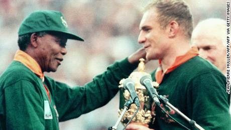 Former South African President Nelson Mandela hands over the Webb Ellis Cup to Springboks skipper François Pienaar in 1995.