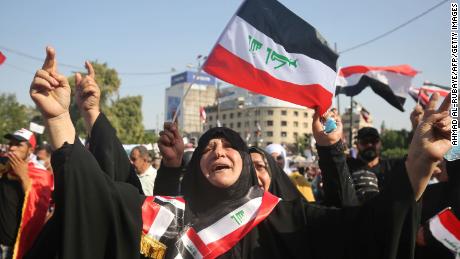 Iraqi women chant slogans and wave national flags as they take part in a protest in the capital Baghdad&#39;s Tahrir Square during anti-government protests on November 4, 2019.