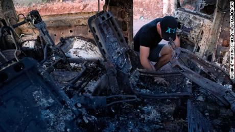 A relative examines the scene where 9 family members were killed in Bavispe, Mexico. 