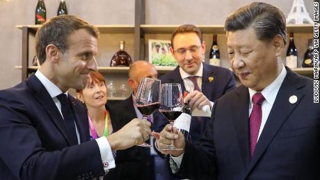 Le président chinois Xi Jinping (à droite) et le président français Emmanuel Macron (à gauche) dégustent du vin lors de leur visite au pavillon de la France lors de l'Exposition internationale d'importation de Chine à Shanghai en novembre 2019.