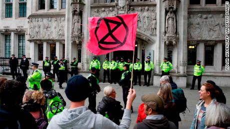 Climate activists protest in front of the Supreme Court, during the eleventh day of demonstrations of the action group against climate change Extinction Rebellion, in London, on October 17, 2019.
