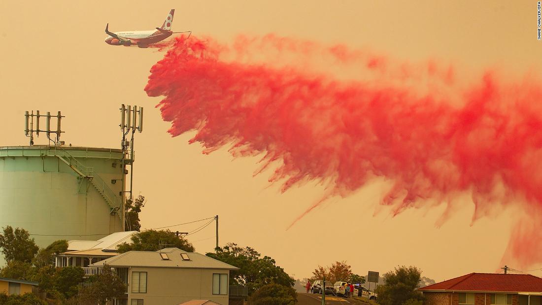 A plane drops fire retardant on a bushfire in Harrington on November 8.