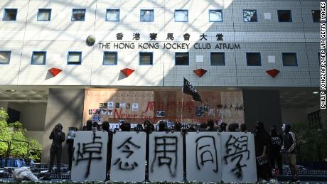 Students of Hong Kong University of Science and Technology (HKUST) hold signs mourning Chow Tsz-lok in Hong Kong on November 8, 2019.