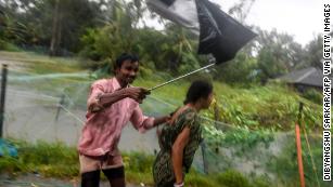 Villagers struggle against strong winds to enter a relief ceter as Cyclone Bulbul approaches eastern India.
