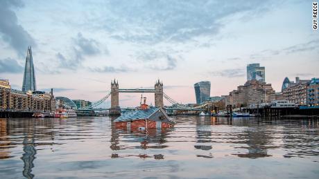 Extinction Rebellion activists sail &#39;sinking house&#39; down River Thames