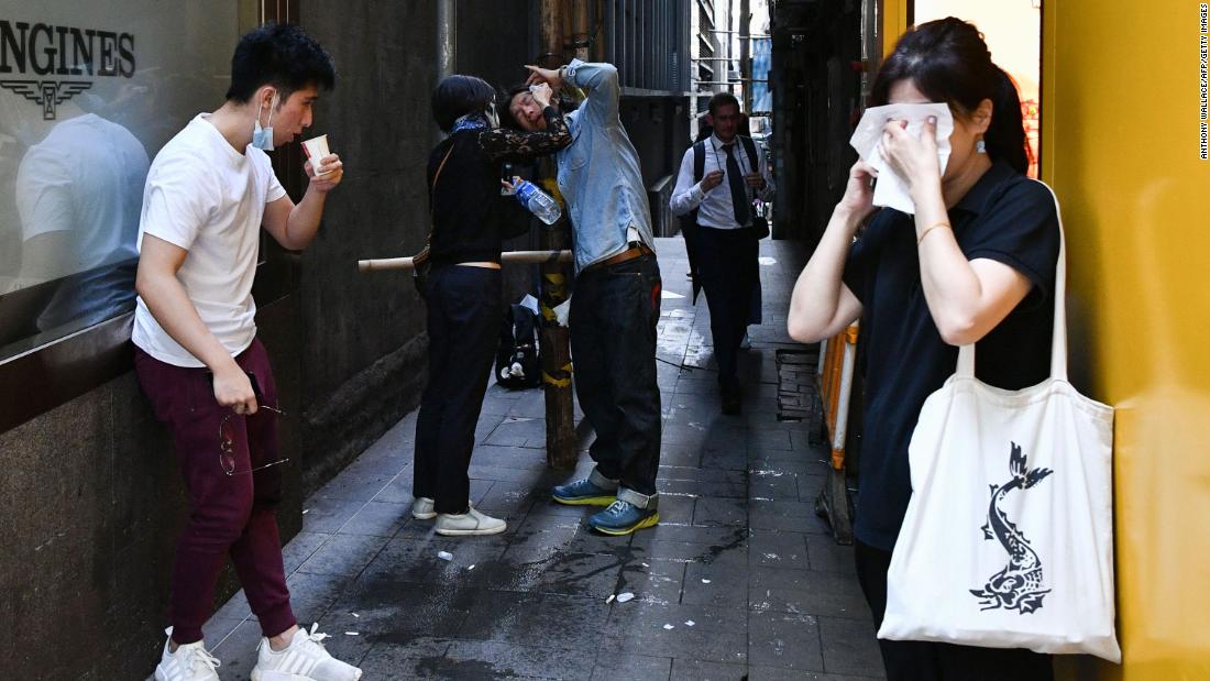 People react after tear gas was fired by police during a protest in Hong Kong&#39;s Central District on November 11.