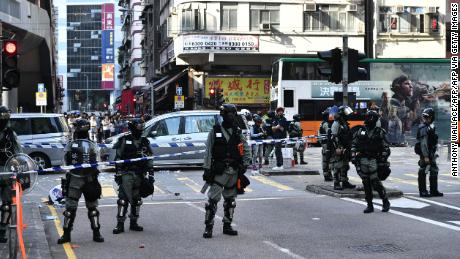 Police officers cordon off an area where pro-democracy protesters were shots by a policeman in Hong Kong on November 11, 2019. - A Hong Kong police officer shot at masked protesters -- hitting at least one in the torso -- during clashes broadcast live on Facebook, as the city&#39;s rush hour was interrupted by protests. (Photo by Anthony WALLACE / AFP) (Photo by ANTHONY WALLACE/AFP via Getty Images)
